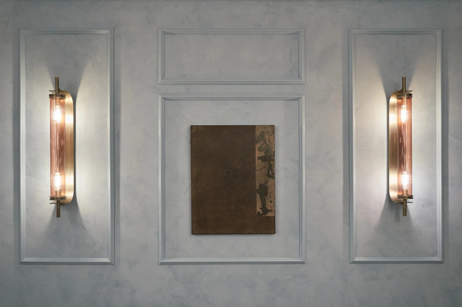 Untitled (GES#1) by Alexandra Yan Wong, hung between two brass wall lights on a pale plaster wall