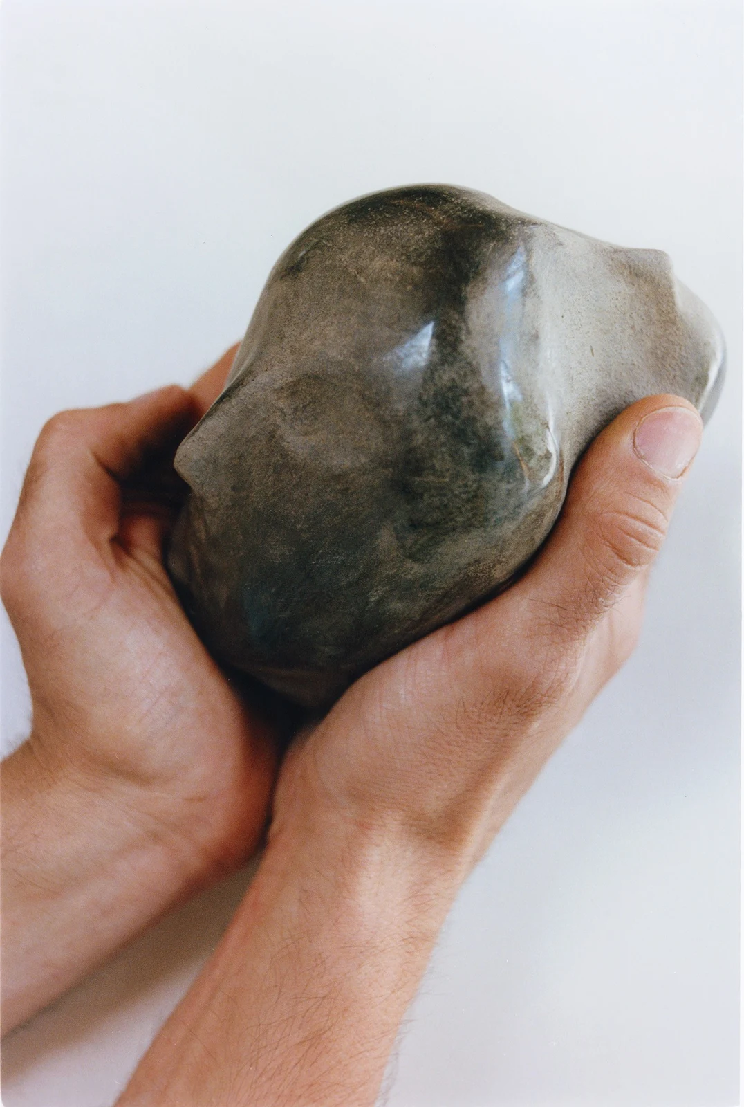All Our Gods Are Dancing Gods by Arran Gregory, held in two cupped hands