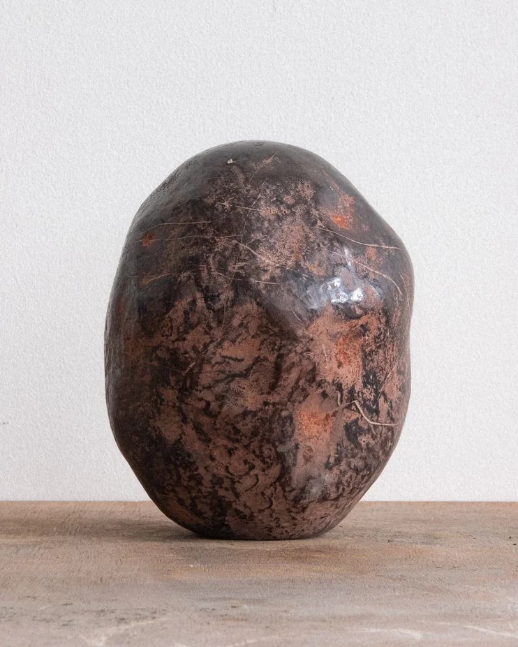 The Universe Was an Egg Which Cracked by Arran Gregory, seen in studio light on a wooden table