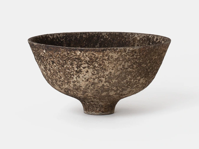 Bowl III by Louis Vincent, a deep footed bowl with a mottled brown and stone-coloured surface, seen from the side