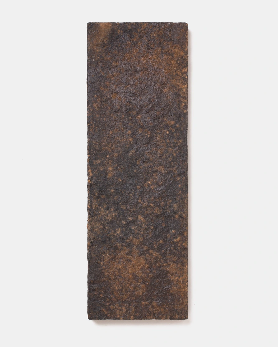 Wall Panel V by Louis Vincent, a dark brown panel with a rust-speckled textured clay surface