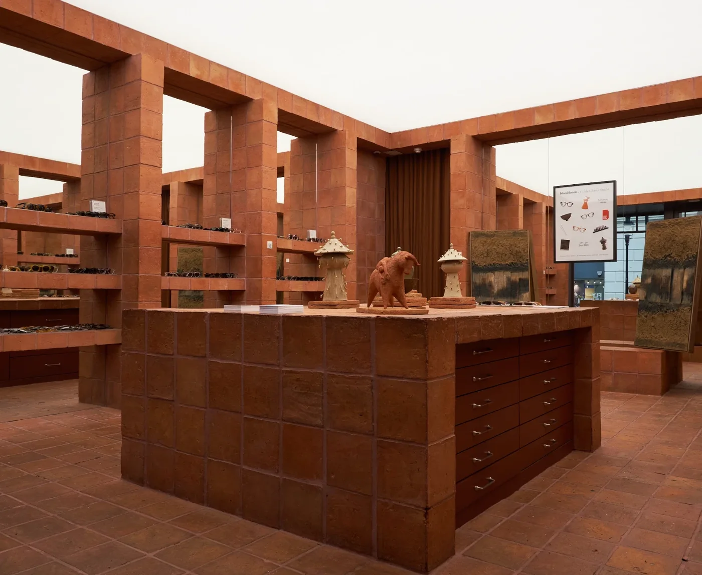 Clay sculptures on a tiled display counter among terracotta shelving at Bloobloom Covent Garden
