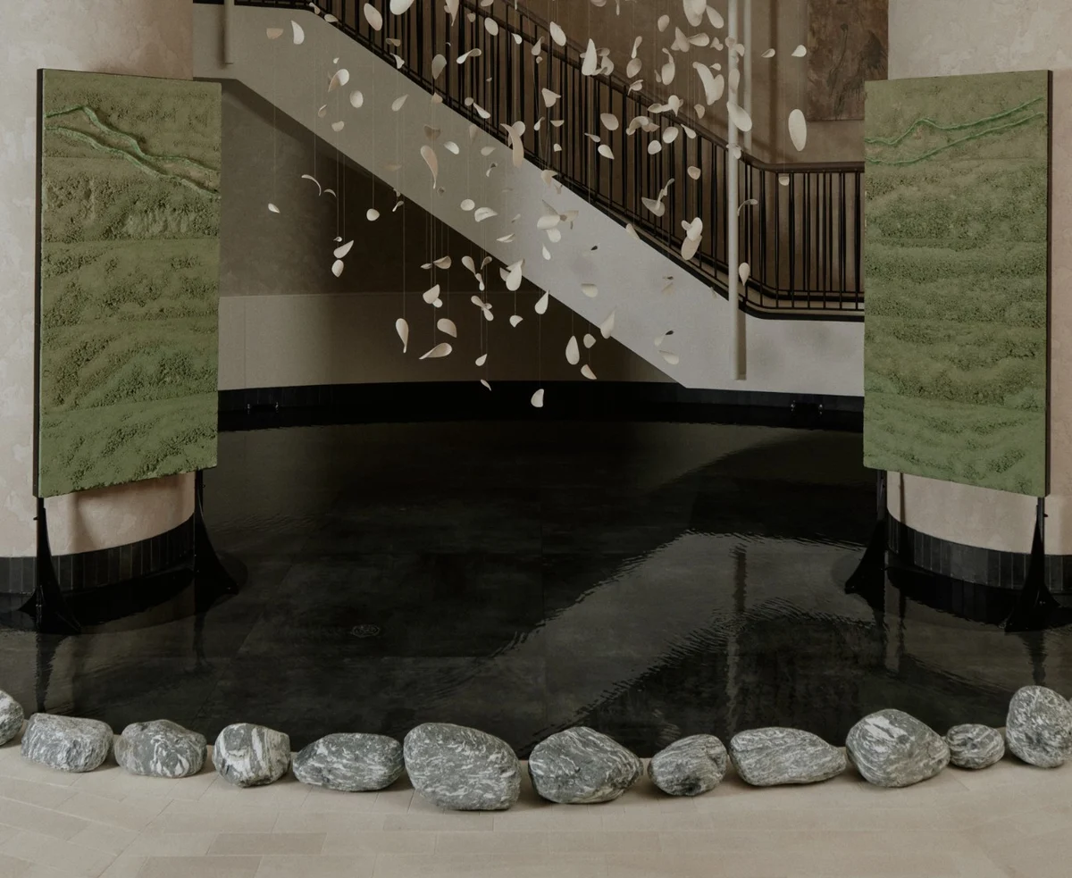 Adam Weismann's Terre Verte panels either side of a pool beneath a suspended petal installation at Six Senses London