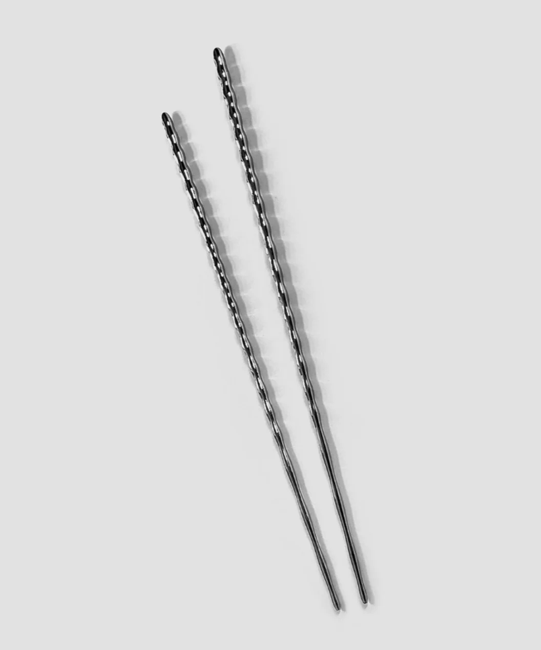 Pair of steel chopsticks by Rickie Cheuk